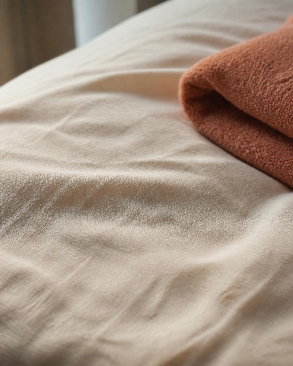 Soft ivory linen folds in warm daylight